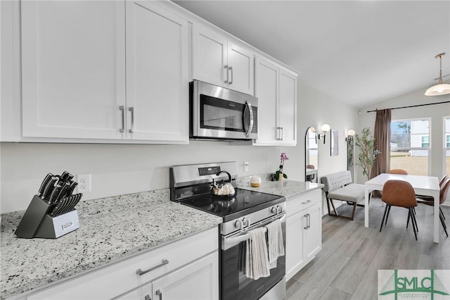 kitchen with pendant lighting, light hardwood / wood-style flooring, appliances with stainless steel finishes, light stone countertops, and white cabinets