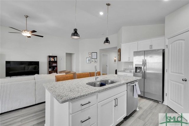 kitchen with white cabinetry, sink, an island with sink, and appliances with stainless steel finishes