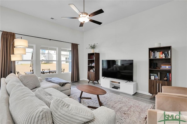 living room with ceiling fan and light hardwood / wood-style floors