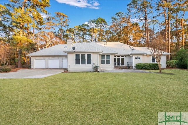 view of front of house featuring a garage and a front lawn