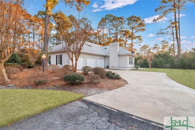 view of side of property with a garage and a yard