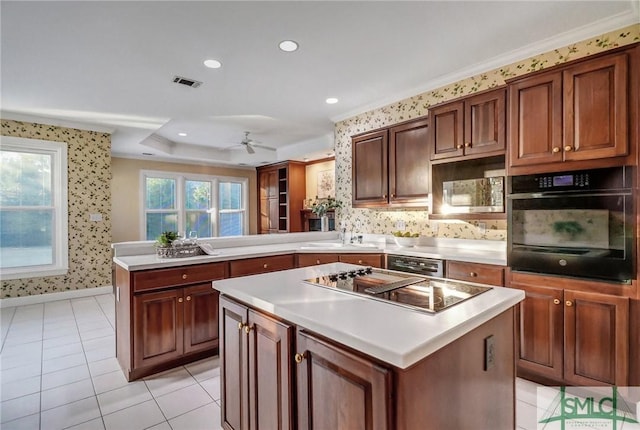 kitchen with a center island, sink, kitchen peninsula, and black appliances