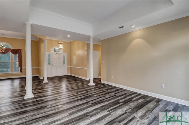 unfurnished living room with ornate columns, crown molding, dark hardwood / wood-style flooring, and a tray ceiling