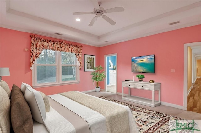 carpeted bedroom featuring a raised ceiling and ceiling fan