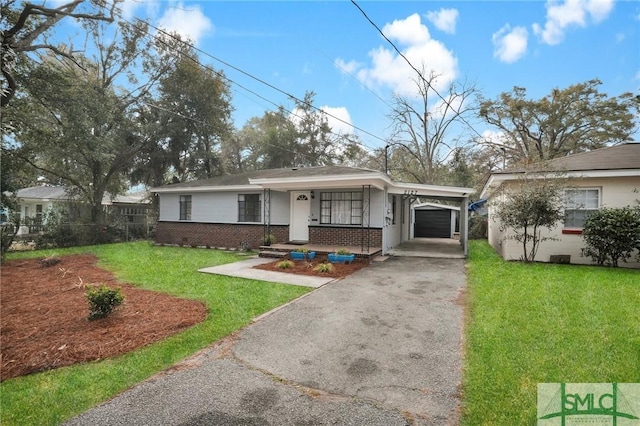 view of front of house with a garage, a front yard, a carport, and a porch