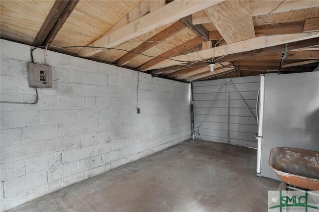 interior space with stainless steel fridge and electric panel