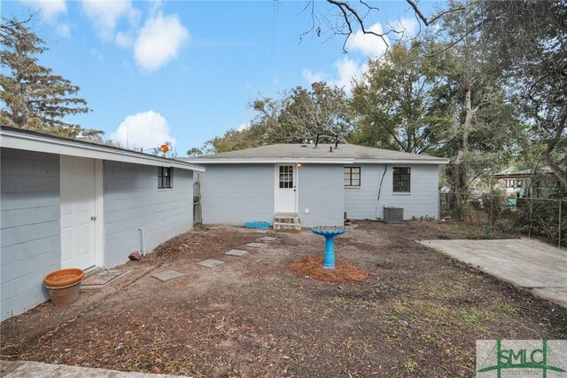 rear view of property featuring cooling unit and a patio area