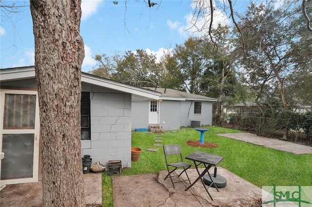 view of yard featuring central air condition unit and a patio area