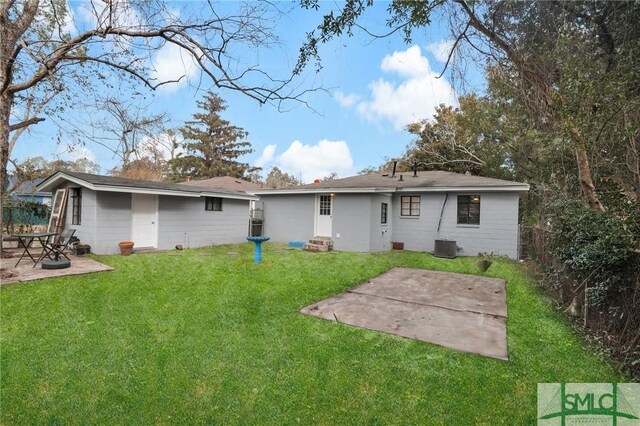 rear view of house with a patio, a yard, and cooling unit