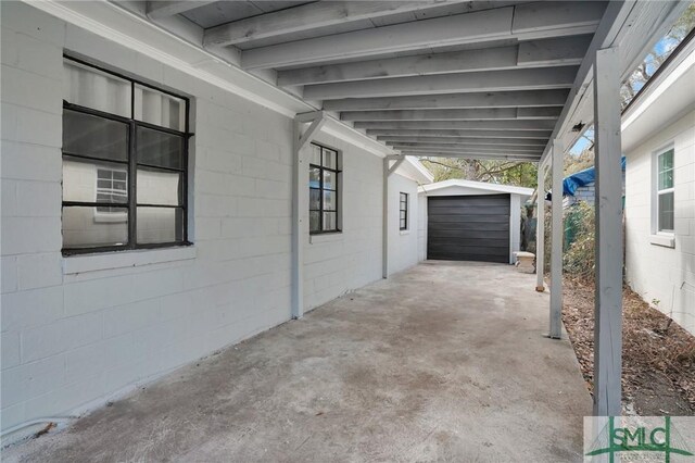 view of patio with a garage and an outdoor structure