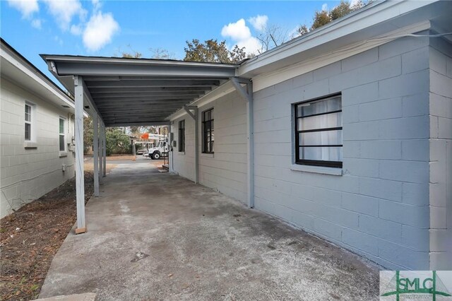 view of vehicle parking with a carport