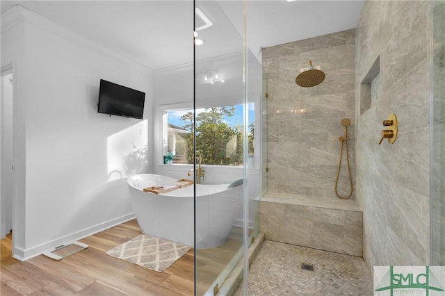 bathroom featuring hardwood / wood-style floors, crown molding, and plus walk in shower