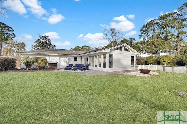 rear view of house featuring a patio and a yard