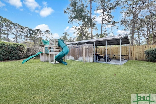 view of play area featuring a lawn and a patio area