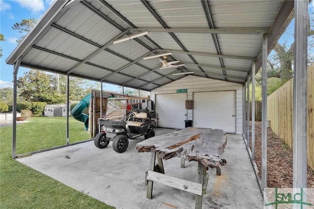 garage with a lawn and a carport