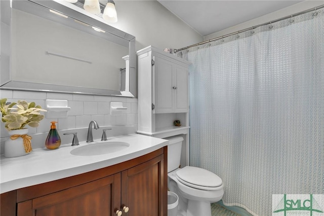 bathroom featuring tasteful backsplash, vanity, a shower with curtain, and toilet