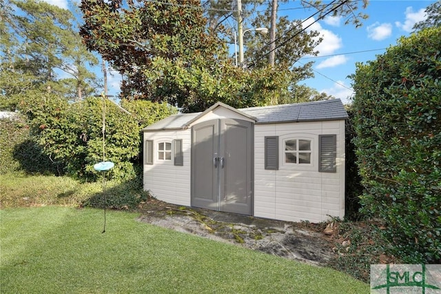 view of outbuilding with a yard