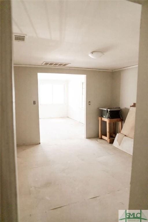 interior space featuring crown molding and concrete floors