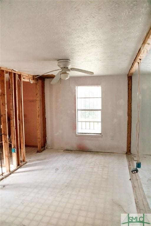 spare room with a textured ceiling and ceiling fan