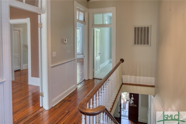 staircase with hardwood / wood-style floors