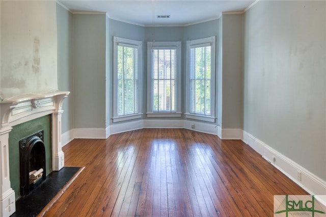 unfurnished living room featuring crown molding and dark hardwood / wood-style floors