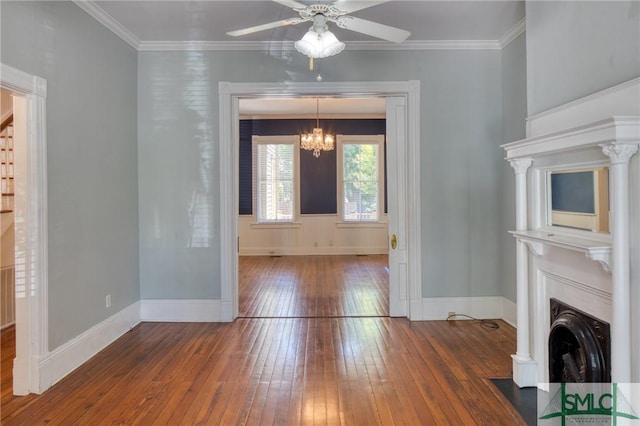 unfurnished dining area featuring ornamental molding, dark hardwood / wood-style flooring, and ceiling fan with notable chandelier