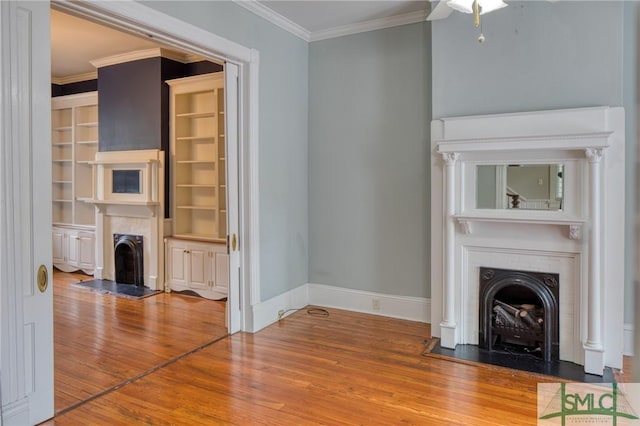 unfurnished living room with crown molding and wood-type flooring