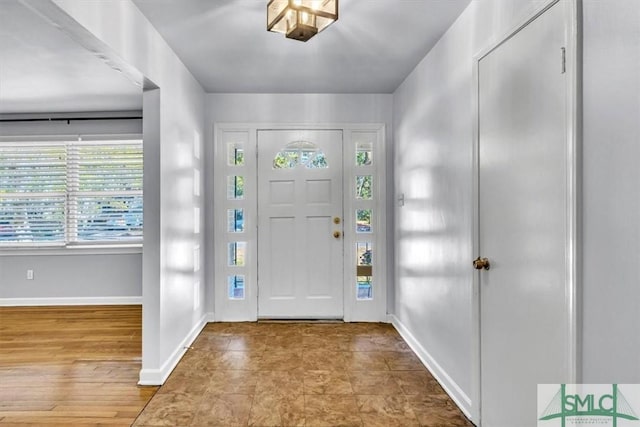 foyer entrance featuring baseboards