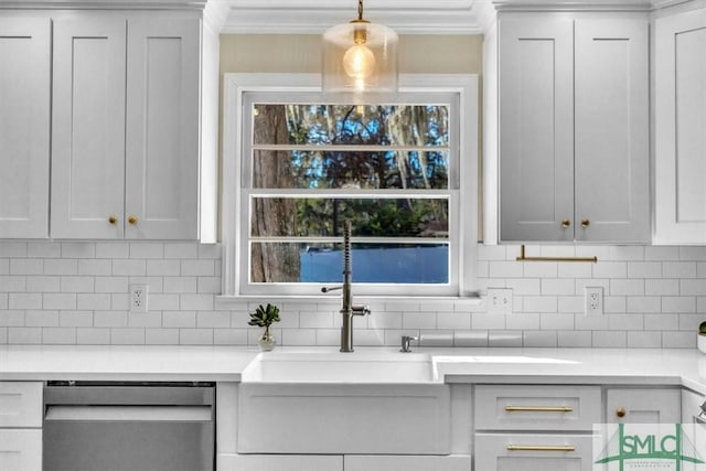 kitchen with pendant lighting, light countertops, stainless steel dishwasher, and white cabinets