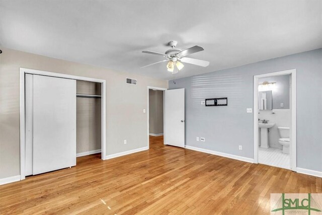 unfurnished bedroom with ensuite bathroom, sink, a closet, ceiling fan, and light hardwood / wood-style floors