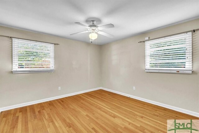 spare room featuring ceiling fan, plenty of natural light, and wood-type flooring