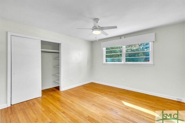 unfurnished bedroom with a closet, ceiling fan, and light wood-type flooring