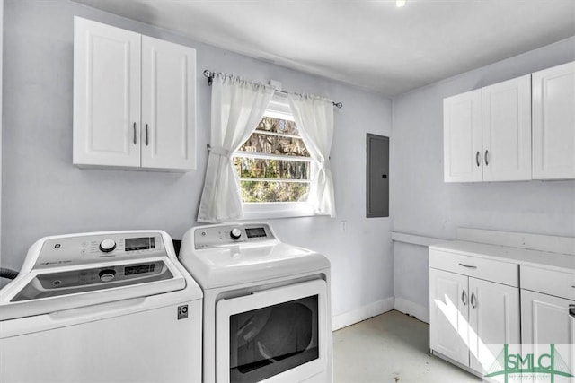 laundry room featuring cabinets, electric panel, and separate washer and dryer