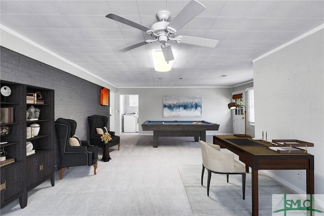 interior space with crown molding, washing machine and clothes dryer, pool table, light colored carpet, and brick wall