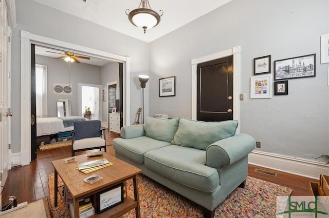 living room featuring hardwood / wood-style floors and ceiling fan