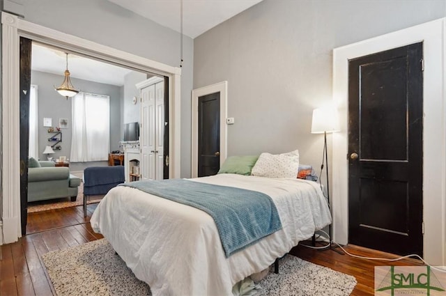 bedroom featuring dark wood-type flooring and a closet