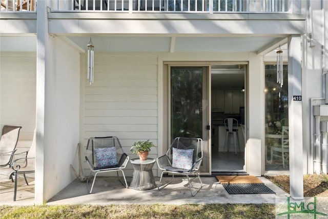 doorway to property with a balcony and a patio