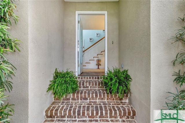 doorway to property with stucco siding