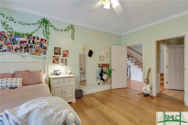 bedroom featuring crown molding, light hardwood / wood-style floors, and ceiling fan