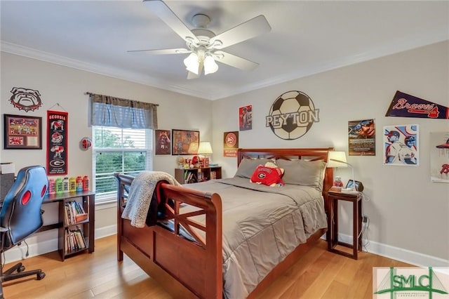 bedroom featuring crown molding, ceiling fan, and light wood-type flooring