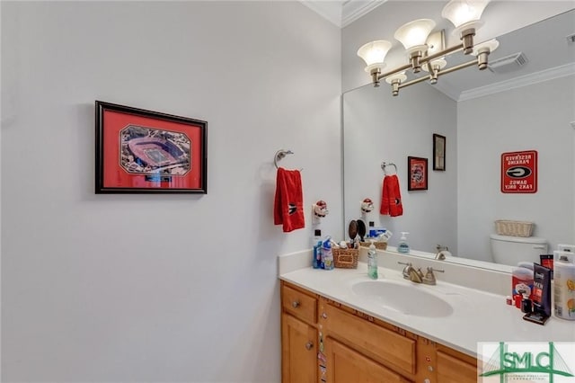 bathroom featuring vanity, crown molding, a chandelier, and toilet