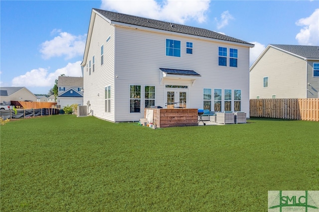 rear view of house with an outdoor hangout area, central AC unit, and a lawn