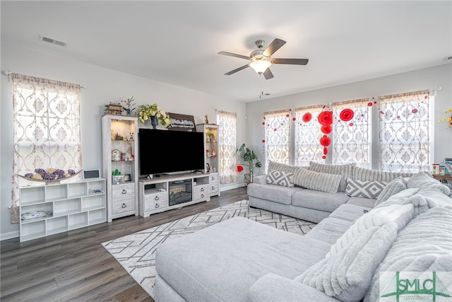 living room featuring dark hardwood / wood-style floors and ceiling fan