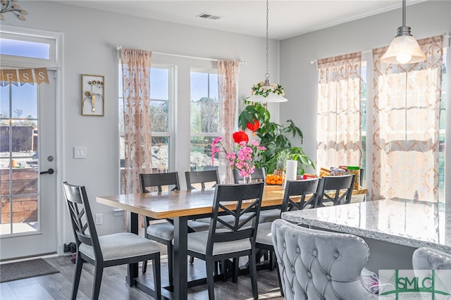 dining space with hardwood / wood-style floors