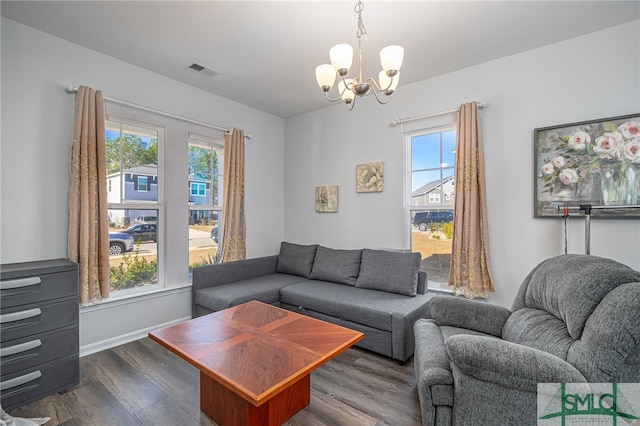 living room featuring dark hardwood / wood-style floors and a notable chandelier