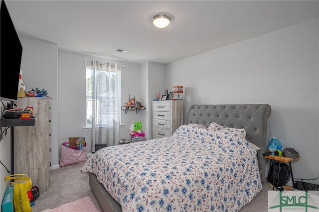 bedroom featuring light carpet