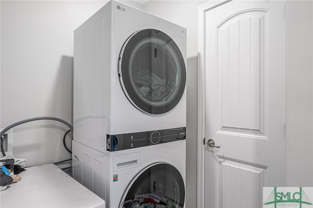 laundry area with stacked washing maching and dryer