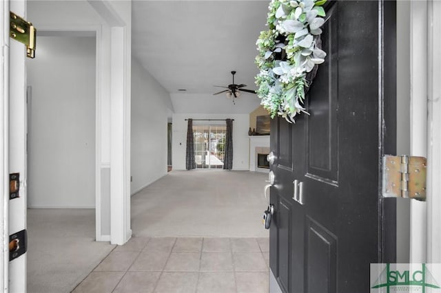 entrance foyer featuring light carpet and ceiling fan