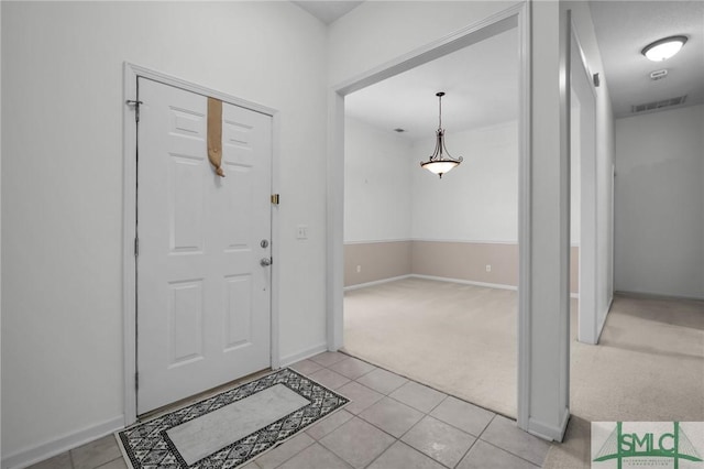 view of carpeted entrance foyer