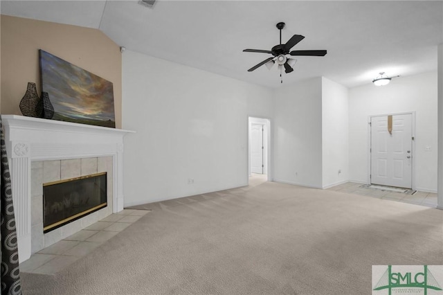 unfurnished living room with a tiled fireplace, light colored carpet, ceiling fan, and lofted ceiling